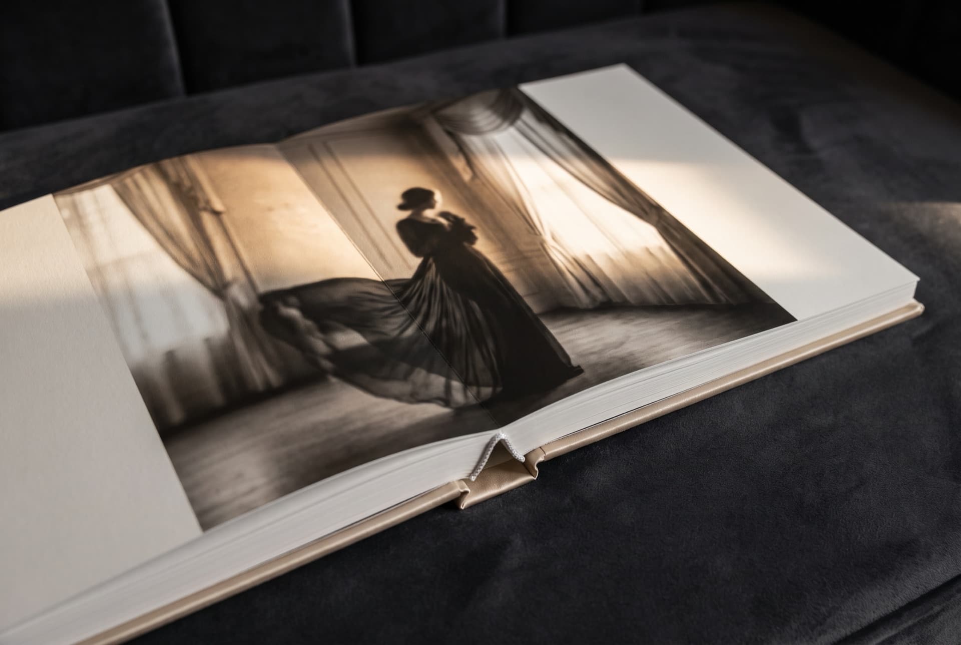 An open lay-flat fine-art boudoir album spread
